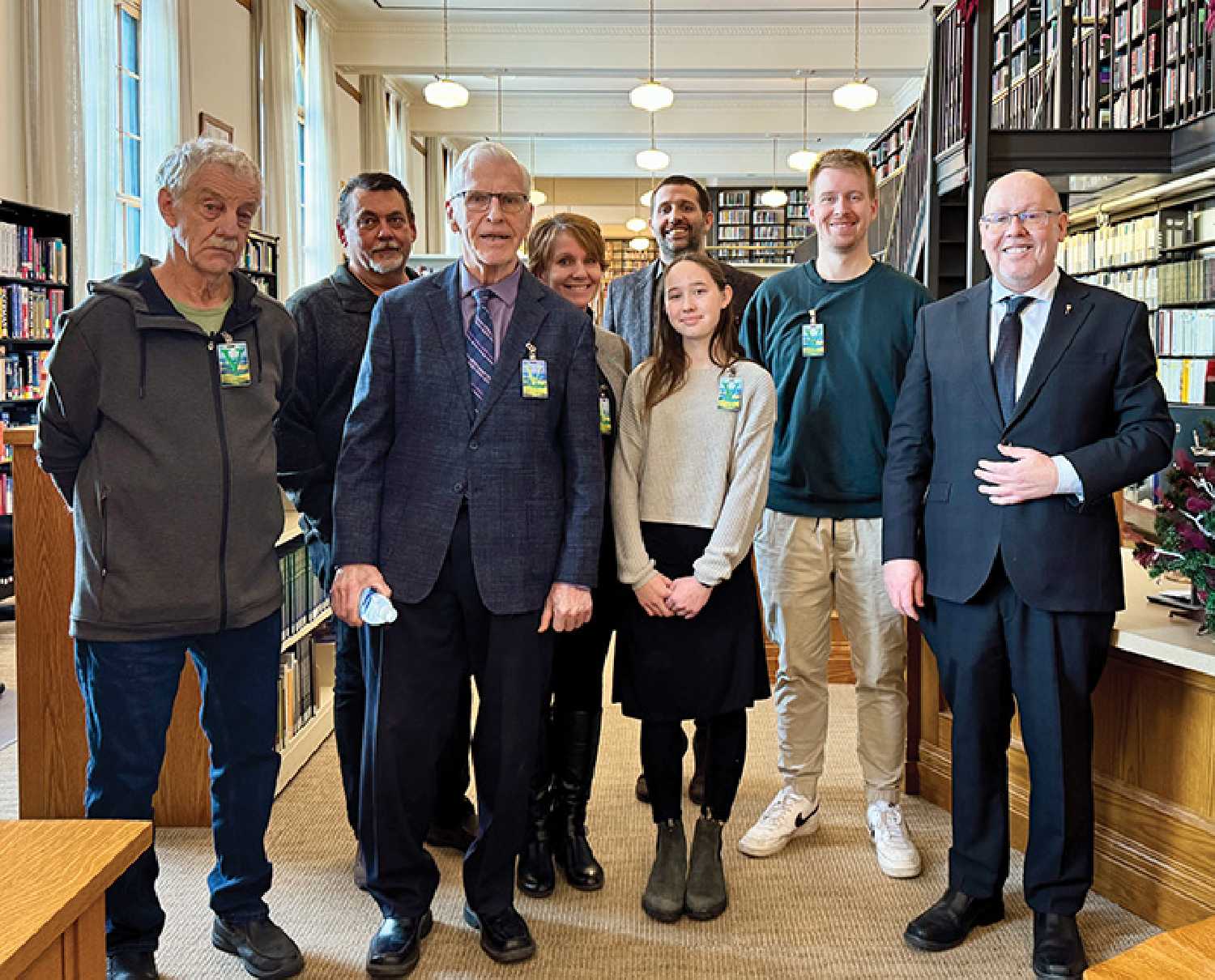 Sinc Harrison with friend Mark Bateman, at left, and some of his family in the Legislative Library.